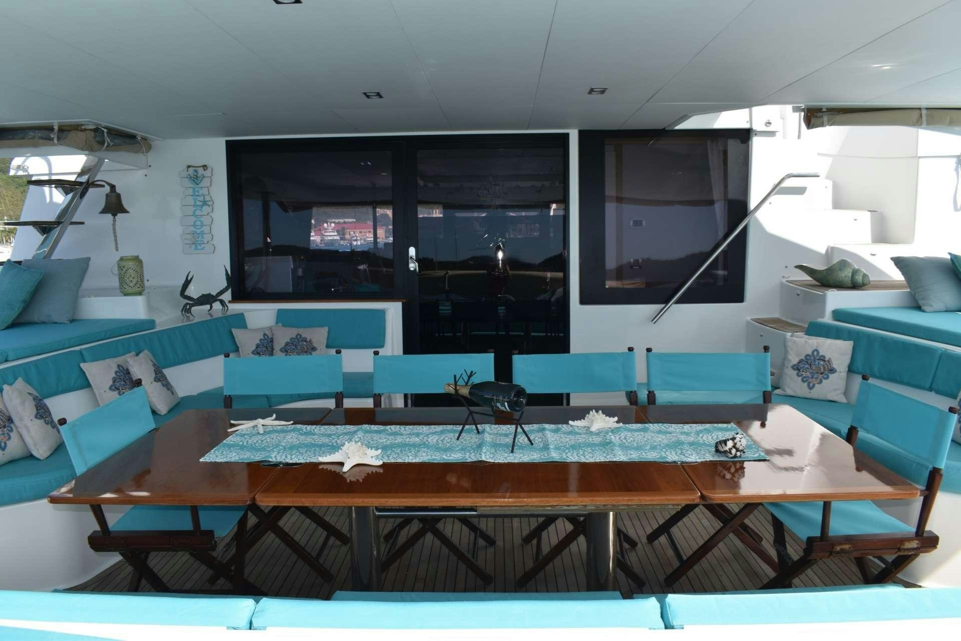 a room with a table and chairs aboard LIR Yacht for Charter