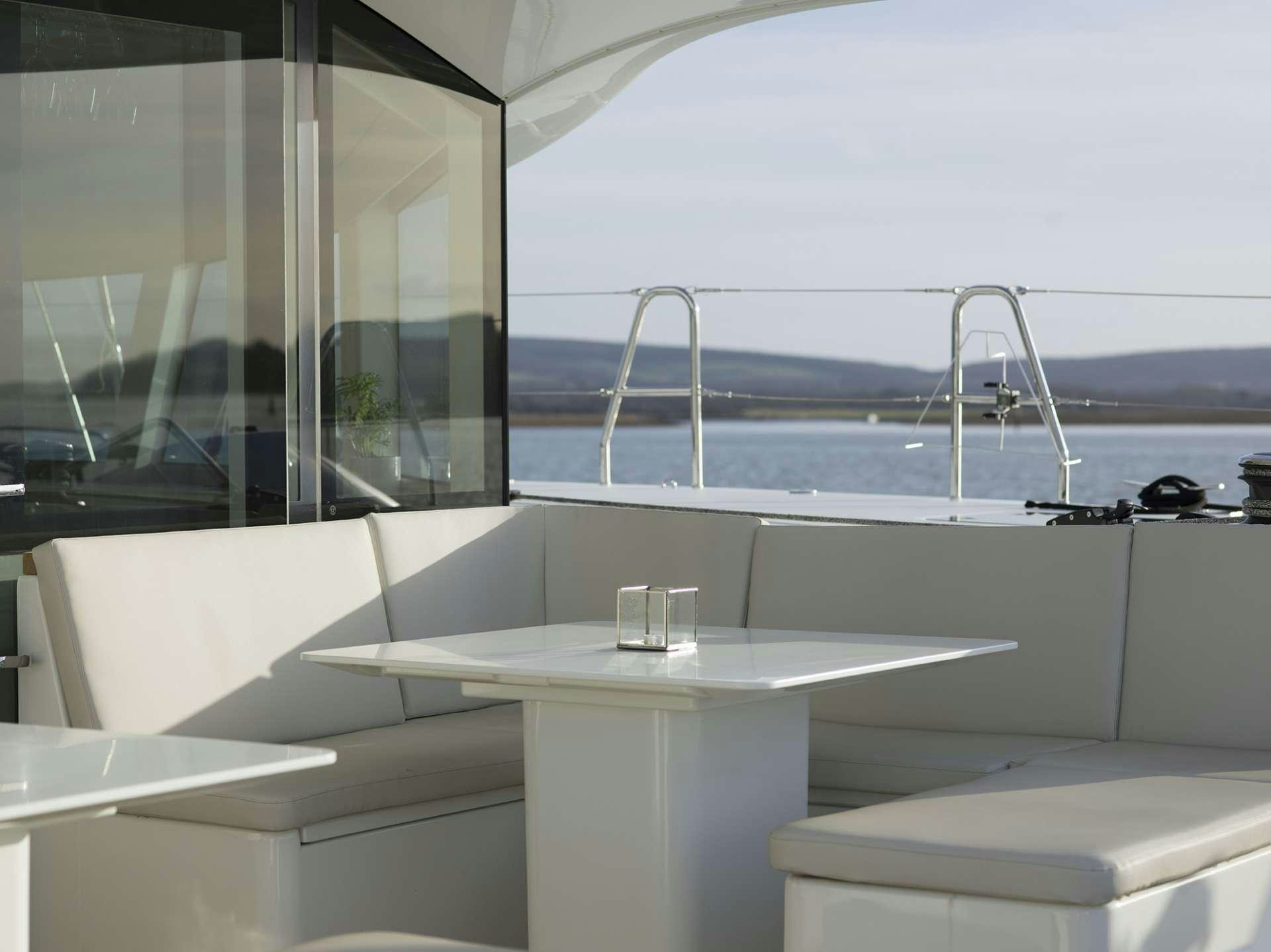 a room with a table and chairs aboard CYGNUS CYGNUS Yacht for Charter