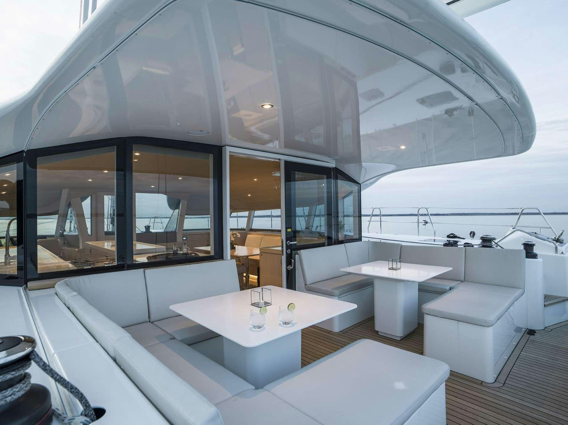 a room with a table and chairs aboard CYGNUS CYGNUS Yacht for Charter