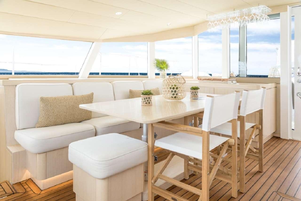 a room with a table and chairs aboard CYGNUS CYGNUS Yacht for Charter