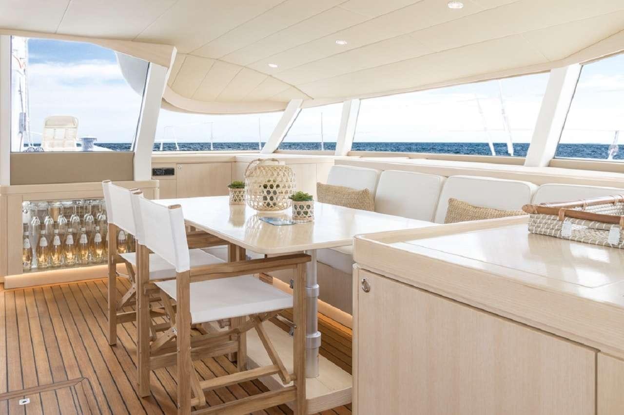 a room with a table and chairs aboard CYGNUS CYGNUS Yacht for Charter