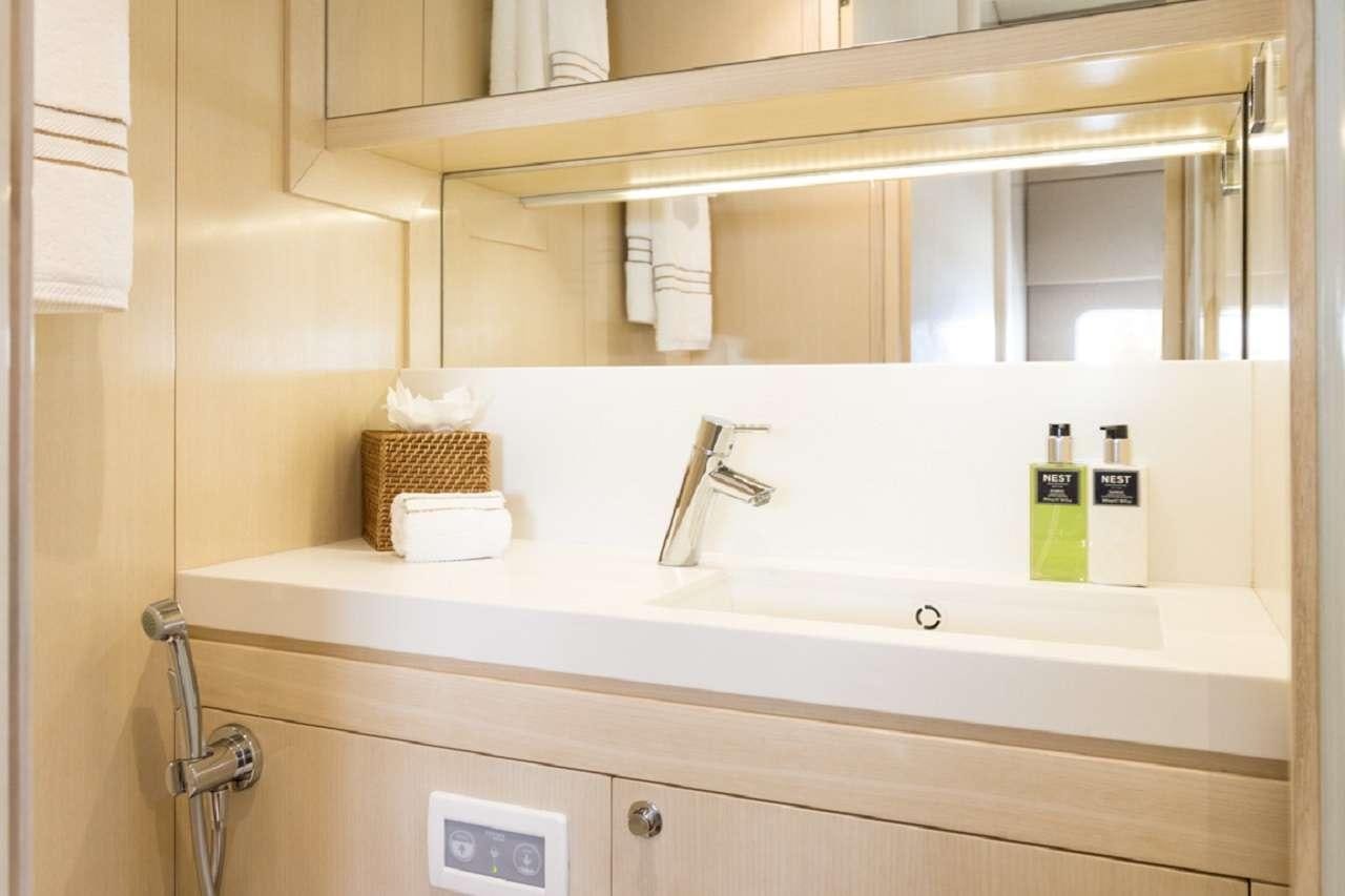 a bathroom with a sink and a mirror aboard CYGNUS CYGNUS Yacht for Charter