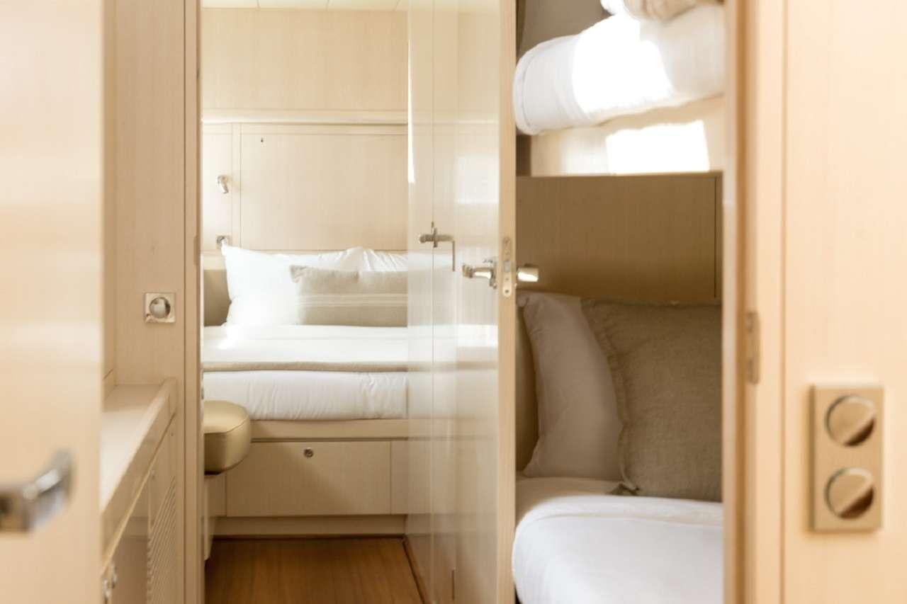 a room with a bed and a couch aboard CYGNUS CYGNUS Yacht for Charter