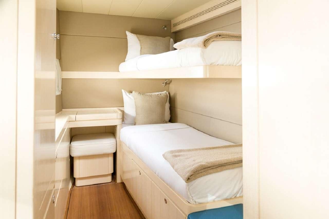 a room with a bed and a shelf aboard CYGNUS CYGNUS Yacht for Charter