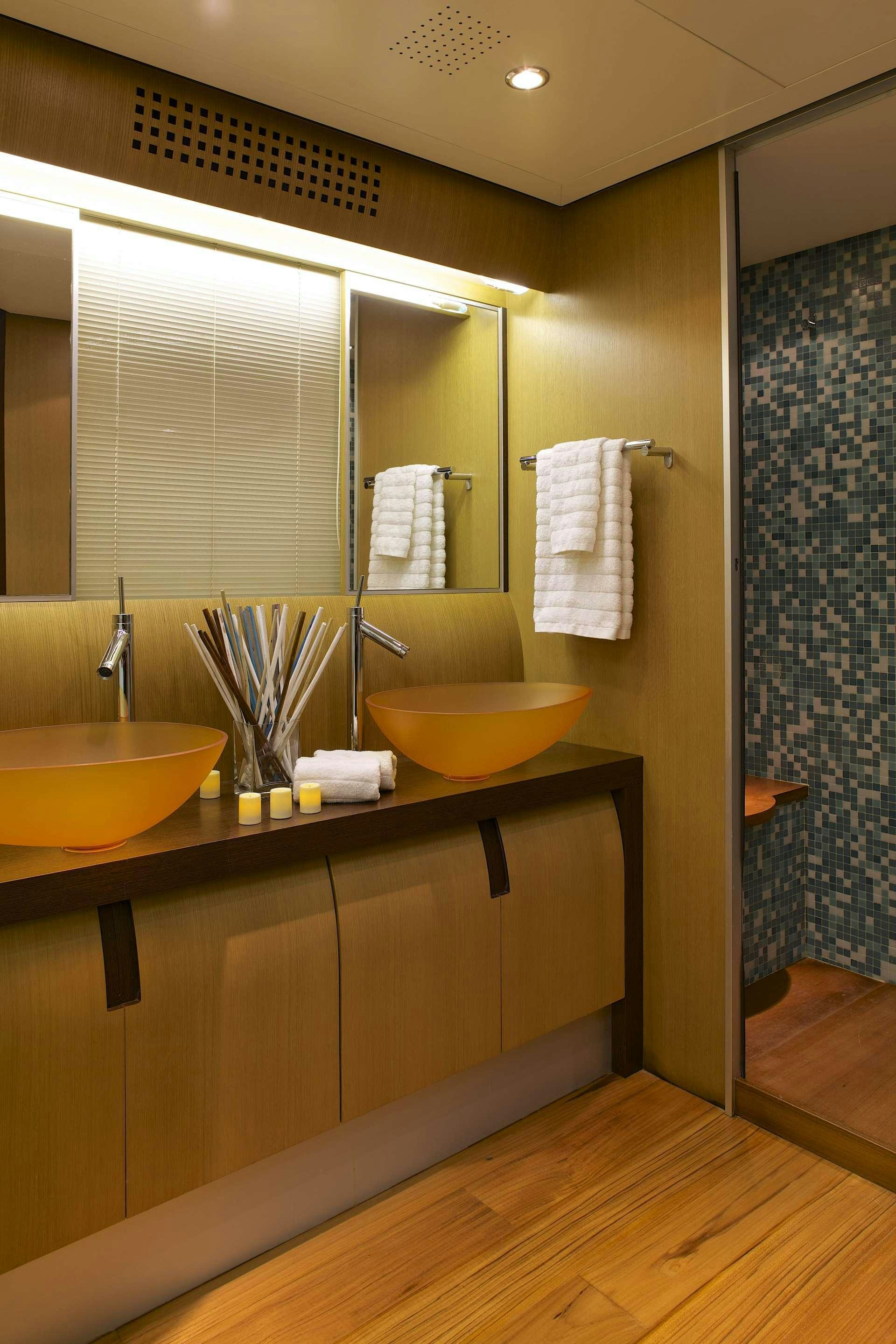 a bathroom with a sink and a mirror aboard SOLARIS Yacht for Charter
