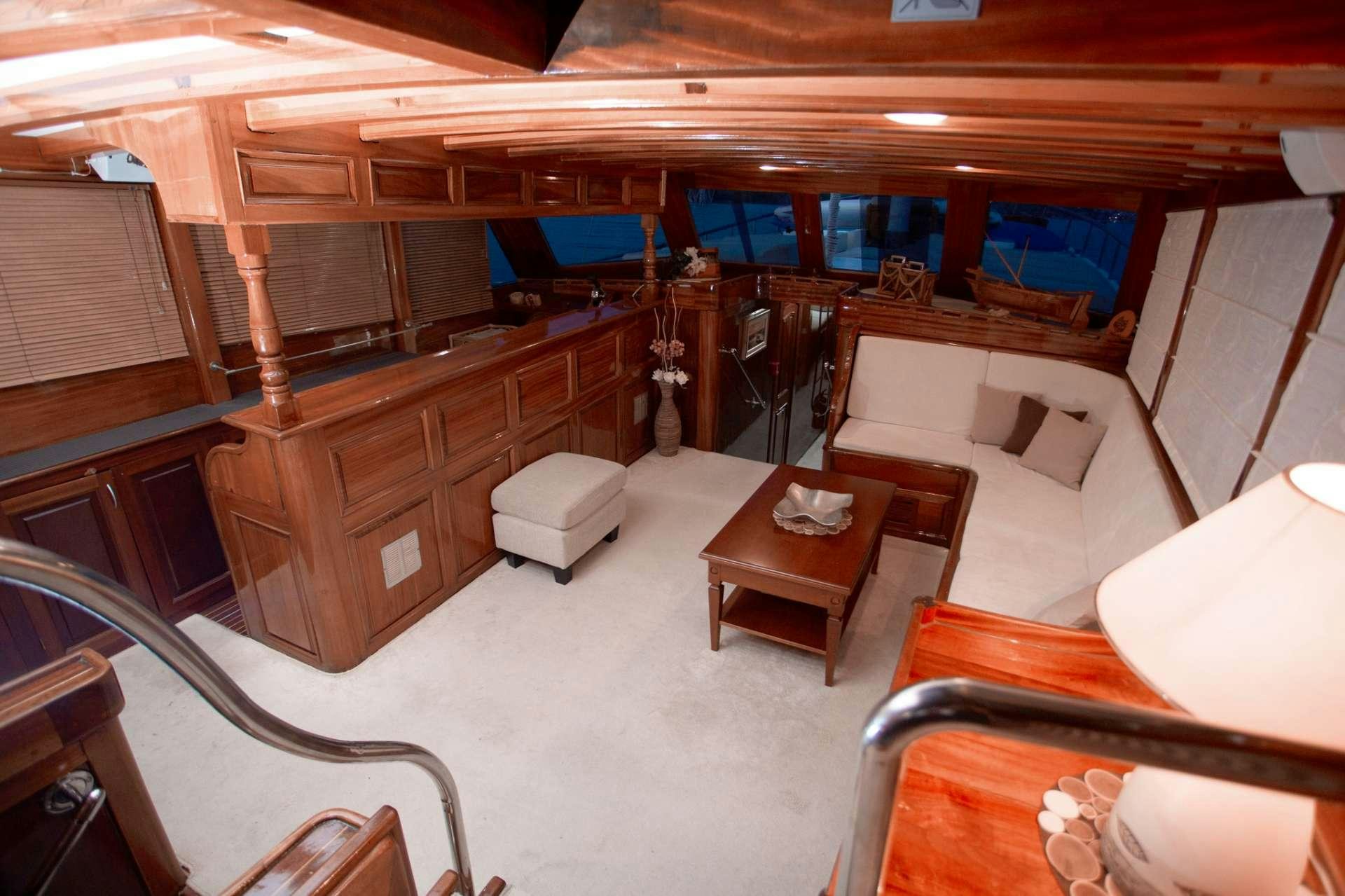 a room with a couch and a table aboard Malena Yacht for Charter