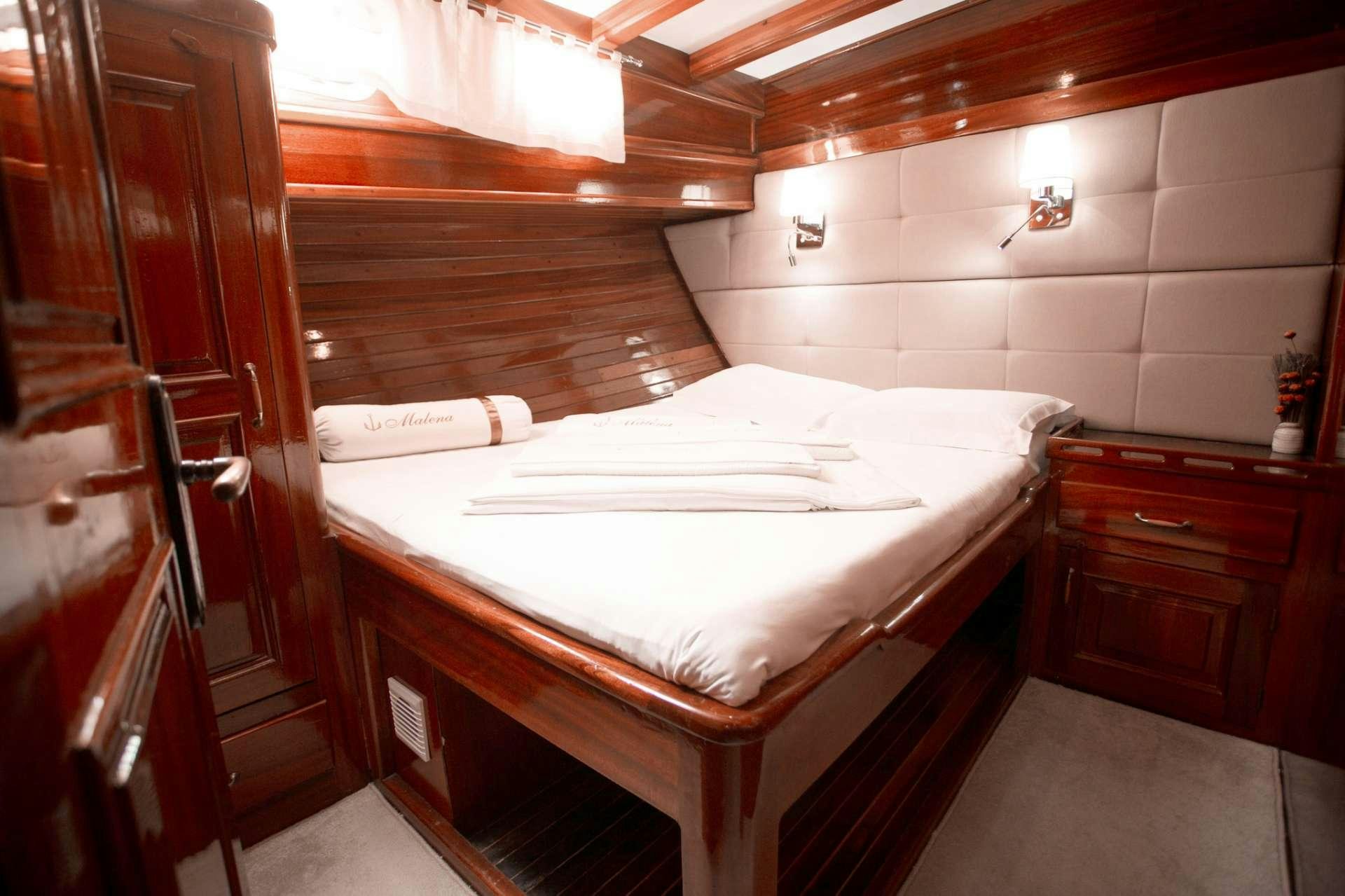 a bed in a room aboard Malena Yacht for Charter