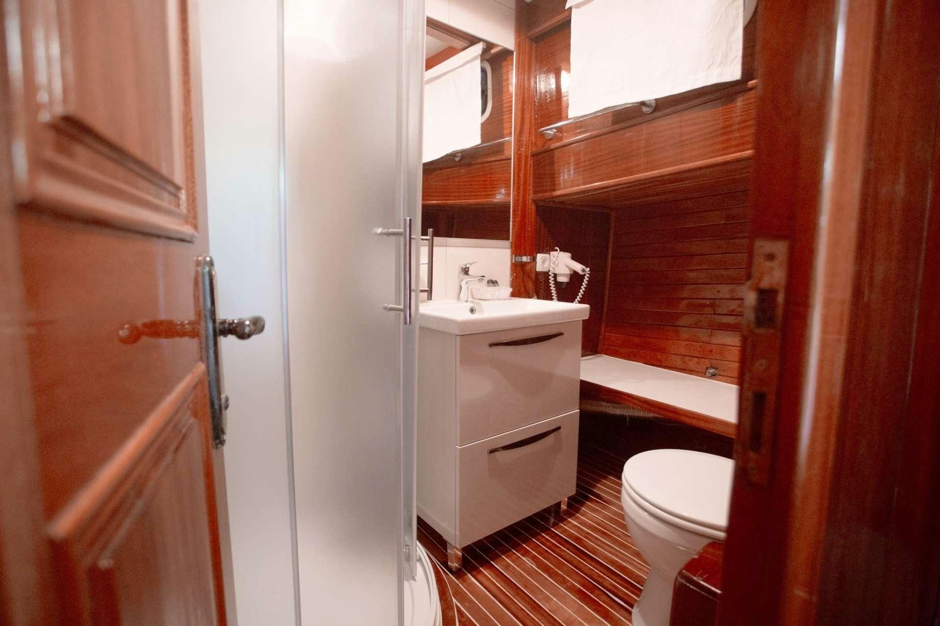 a bathroom with a toilet and sink aboard Malena Yacht for Charter