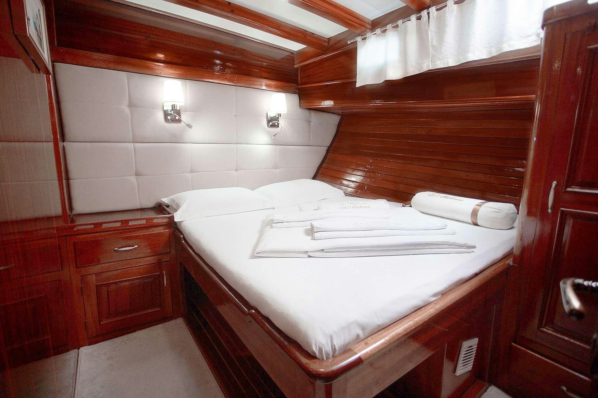 a bed in a room aboard Malena Yacht for Charter