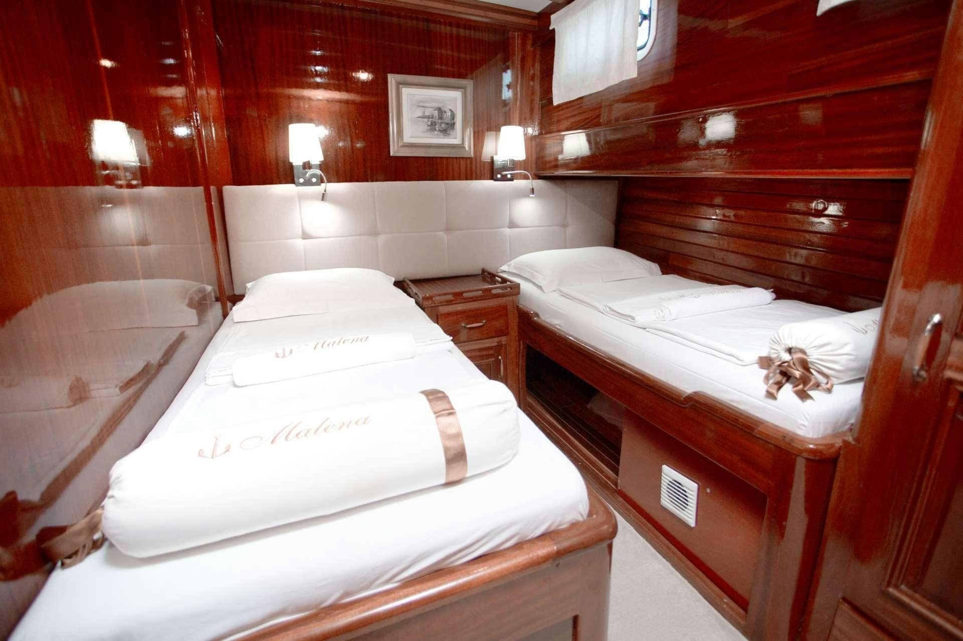 a room with two beds aboard Malena Yacht for Charter