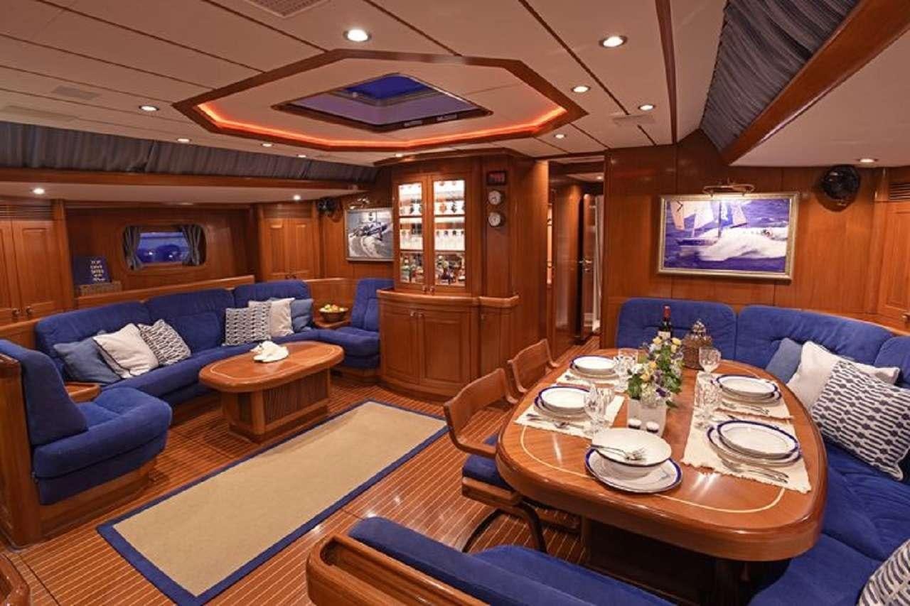 a living room with a table and chairs aboard aquila Yacht for Charter