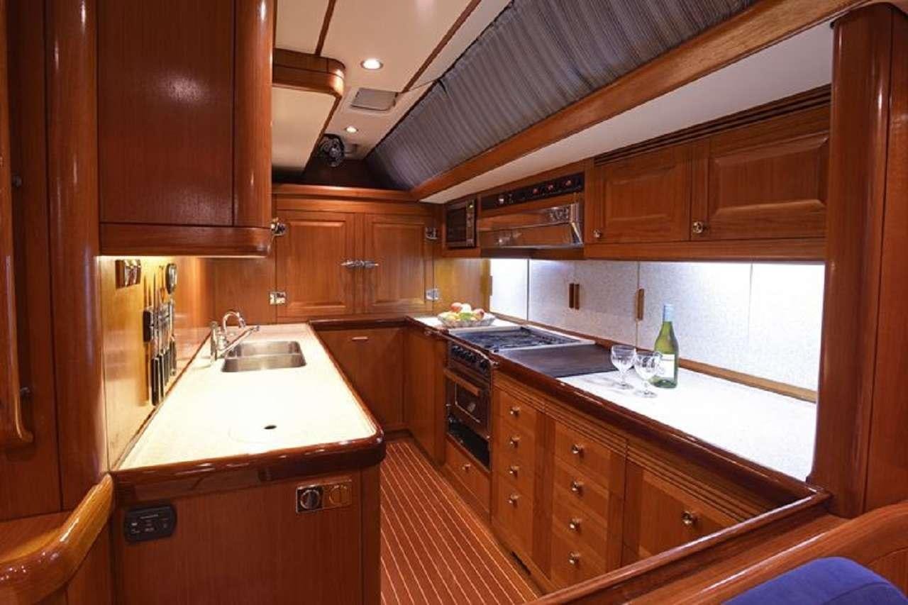 a kitchen with wooden cabinets aboard aquila Yacht for Charter