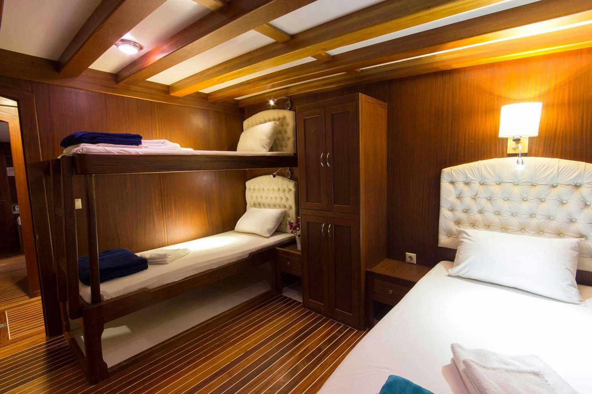 a room with a bed and a desk aboard ATHENA Yacht for Charter