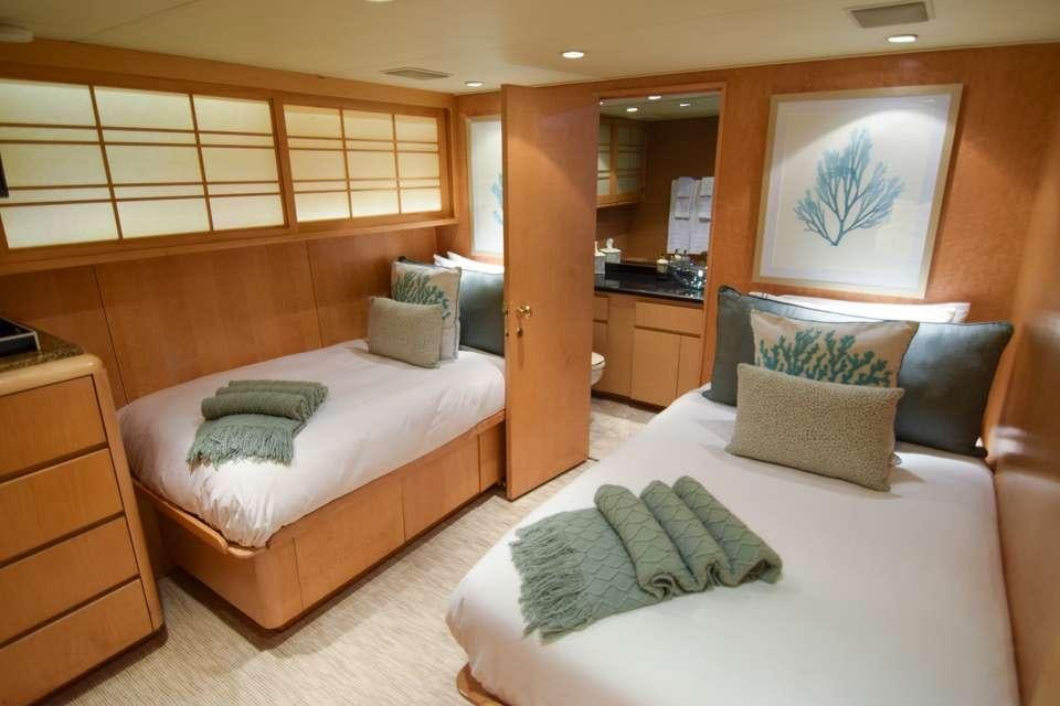 a couple of beds in a hotel room aboard ISLAND VIBES Yacht for Charter