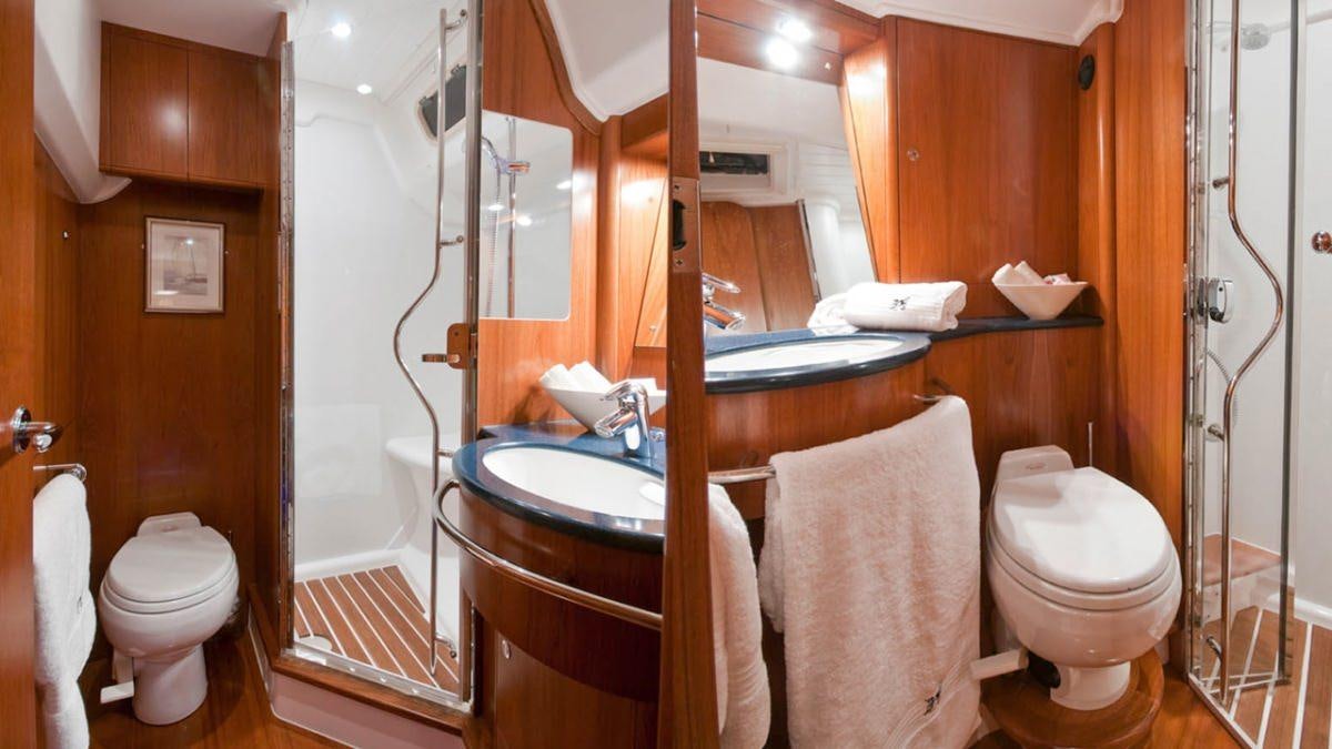 a bathroom with a sink toilet and a bathtub aboard MUSTIQUE Yacht for Charter