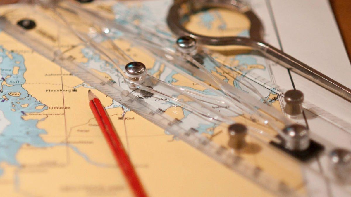 a compass on a map aboard MUSTIQUE Yacht for Charter