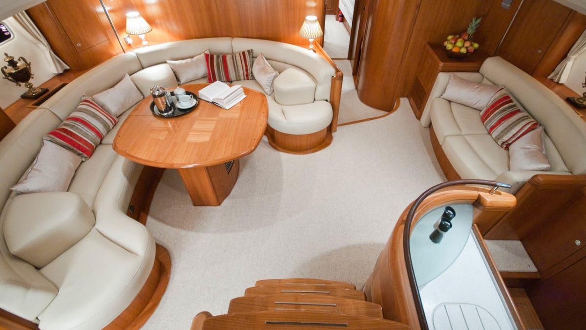 a living room with a couch and a coffee table aboard MUSTIQUE Yacht for Charter