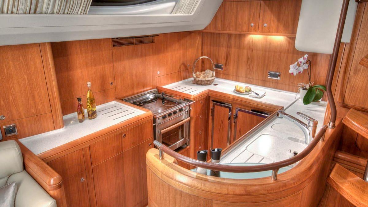 a kitchen with wooden cabinets aboard MUSTIQUE Yacht for Charter