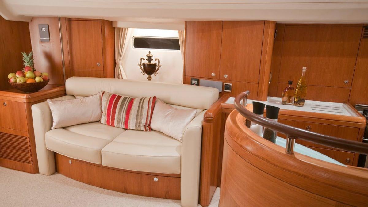 a couch in a room aboard MUSTIQUE Yacht for Charter