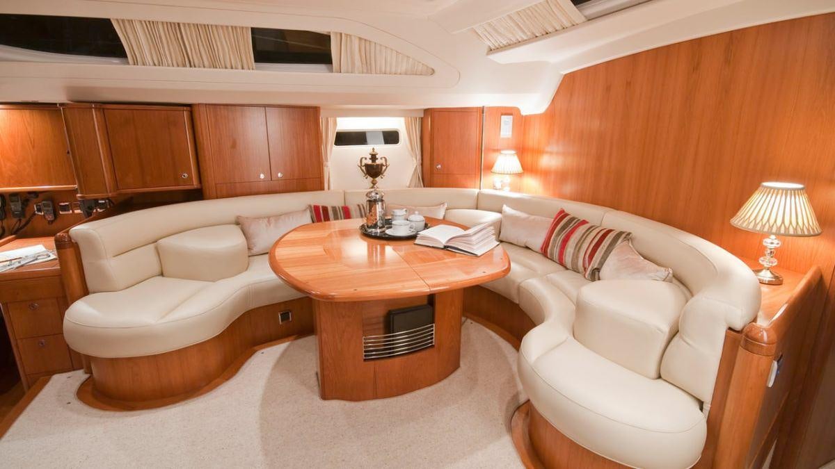a living room with a table and couches aboard MUSTIQUE Yacht for Charter