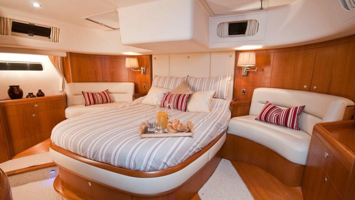 a room with a bed and a couch aboard MUSTIQUE Yacht for Charter