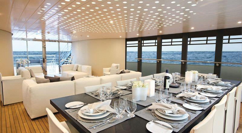 a table set with plates and glasses aboard OCEAN SAPPHIRE Yacht for Charter