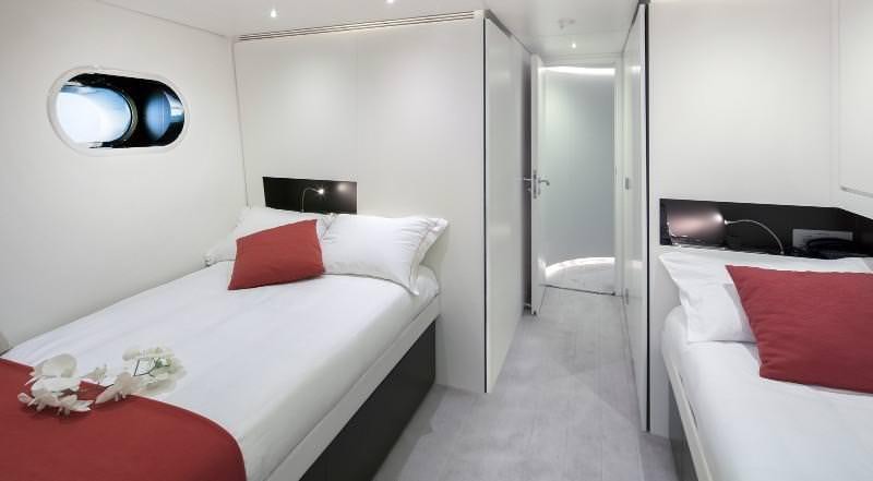 a room with a bed and a television aboard OCEAN SAPPHIRE Yacht for Charter