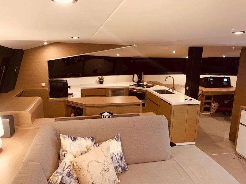 a living room with a couch and a tv aboard LA LINEA Yacht for Charter