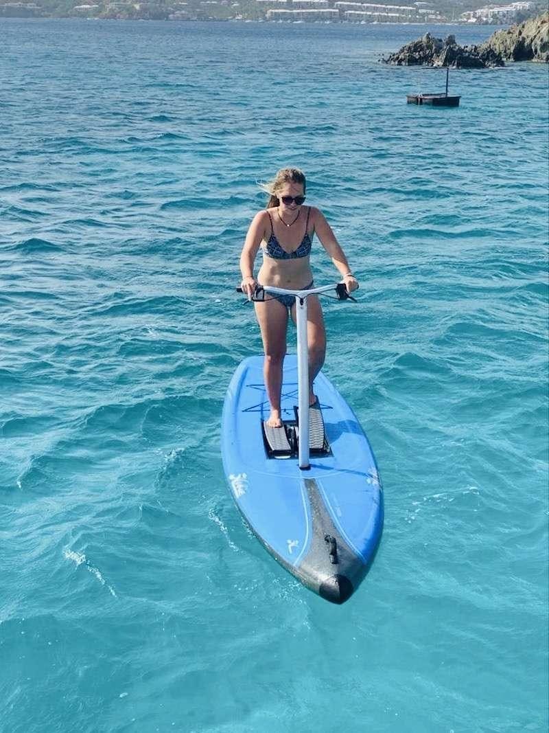 a person on a surfboard aboard LA LINEA Yacht for Charter