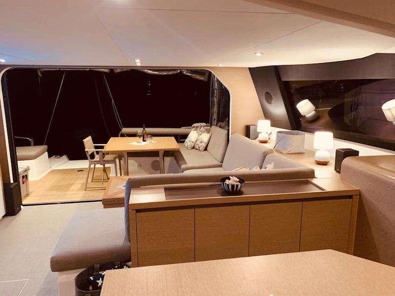 a room with a couch and a table aboard LA LINEA Yacht for Charter