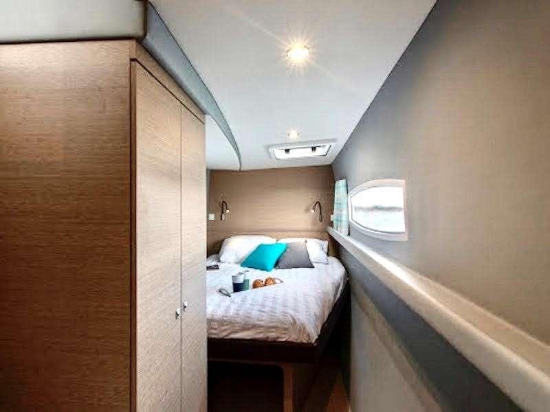 a room with a bed and a door aboard LA LINEA Yacht for Charter