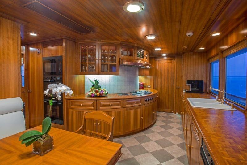 a kitchen with wooden cabinets aboard LADY VICTORIA Yacht for Charter