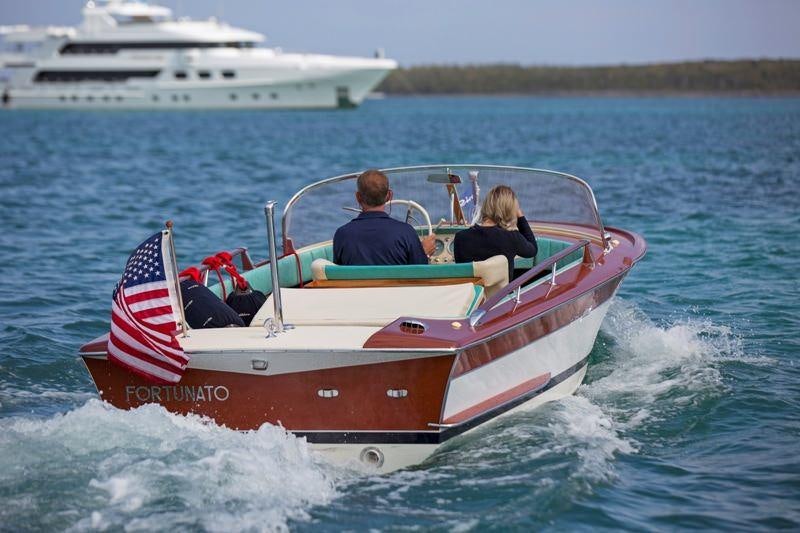 a boat with a flag on it aboard LADY VICTORIA Yacht for Charter