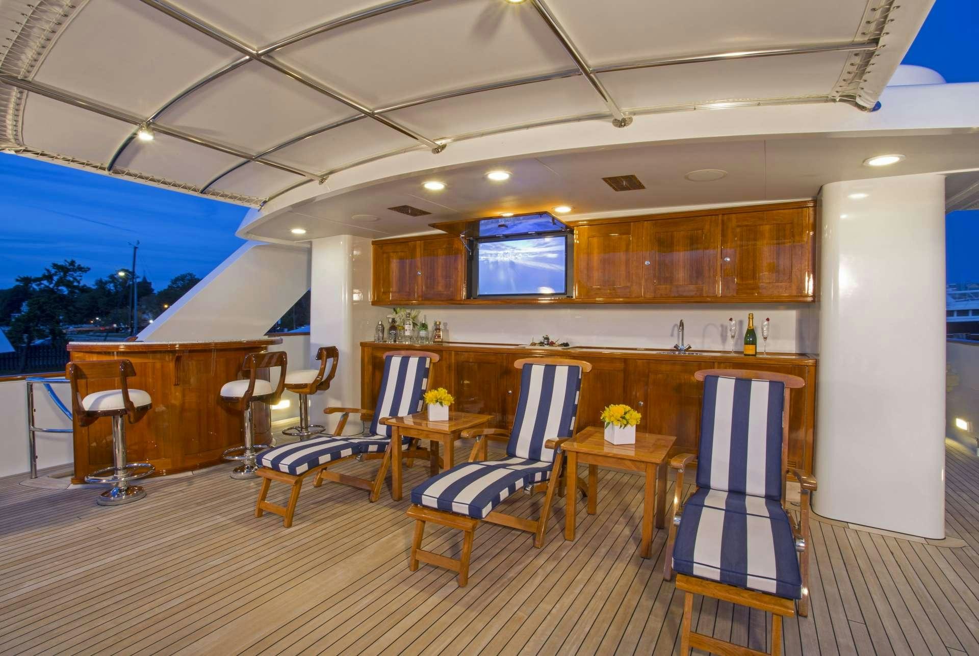 a room with a table chairs and a large window aboard LADY VICTORIA Yacht for Charter