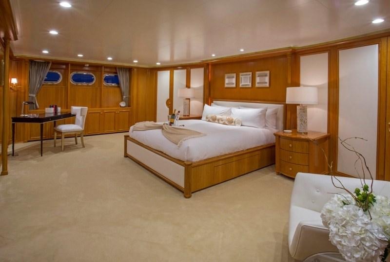 a hotel room with a bed and a table aboard LADY VICTORIA Yacht for Charter