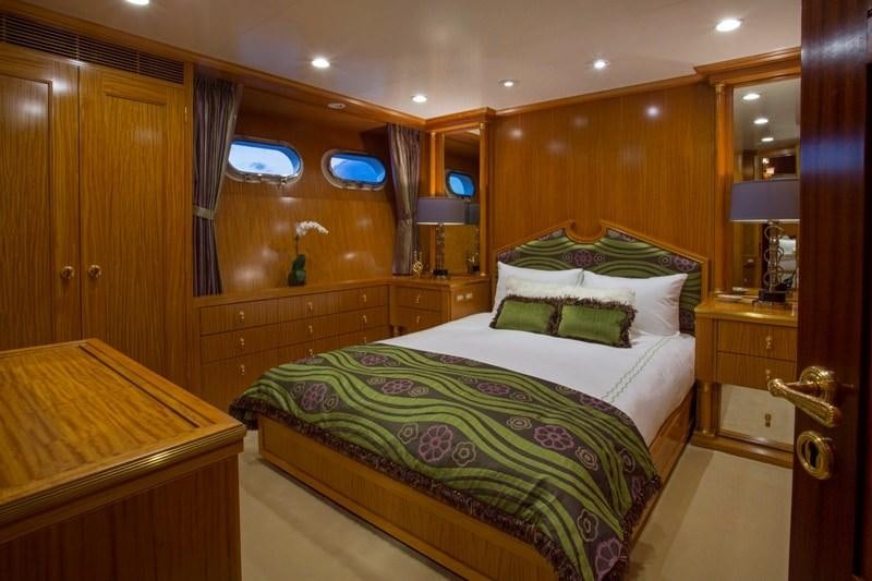 a bedroom with a bed and a desk aboard LADY VICTORIA Yacht for Charter