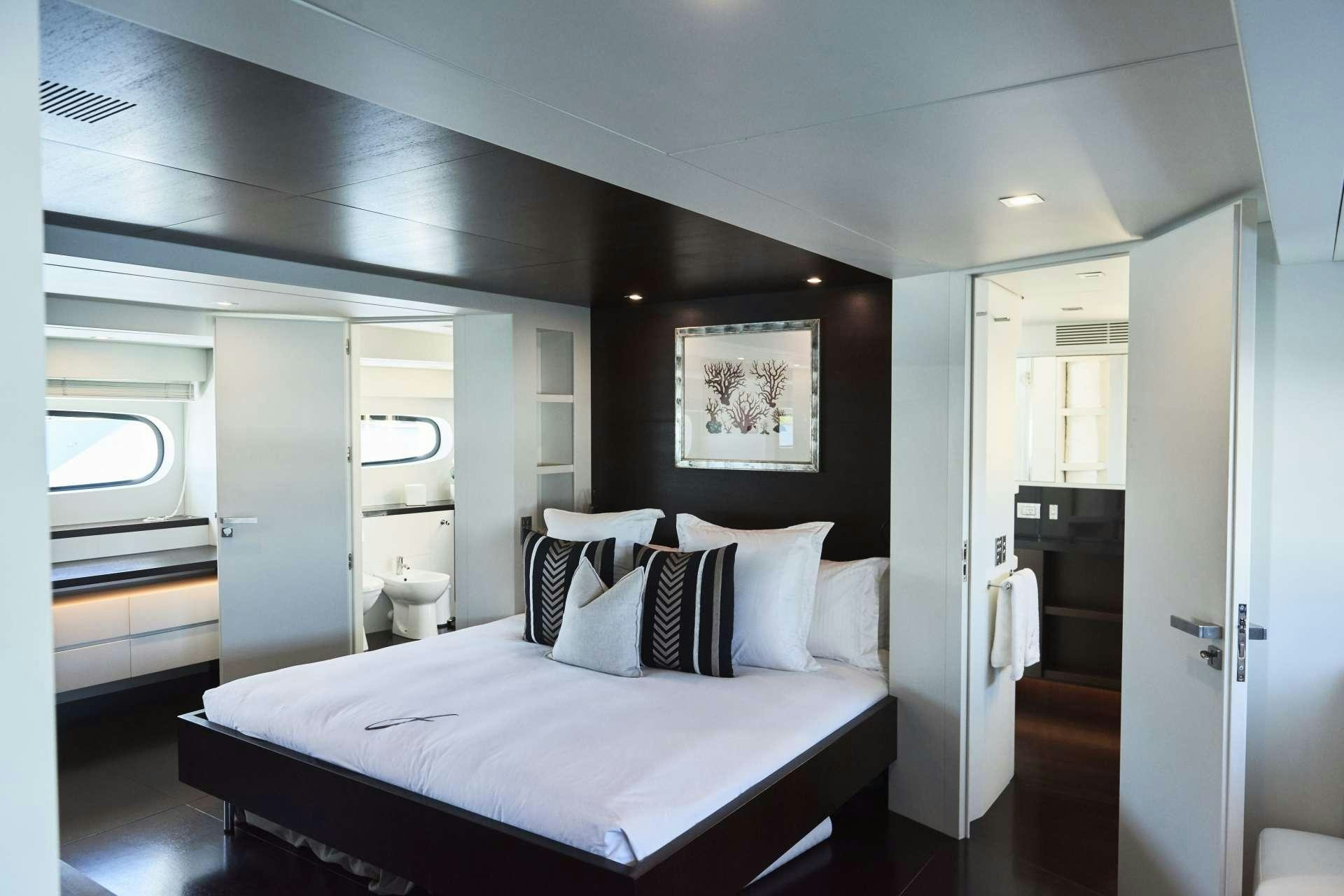 a large bedroom with a large bed aboard IMPULSIVE Yacht for Charter