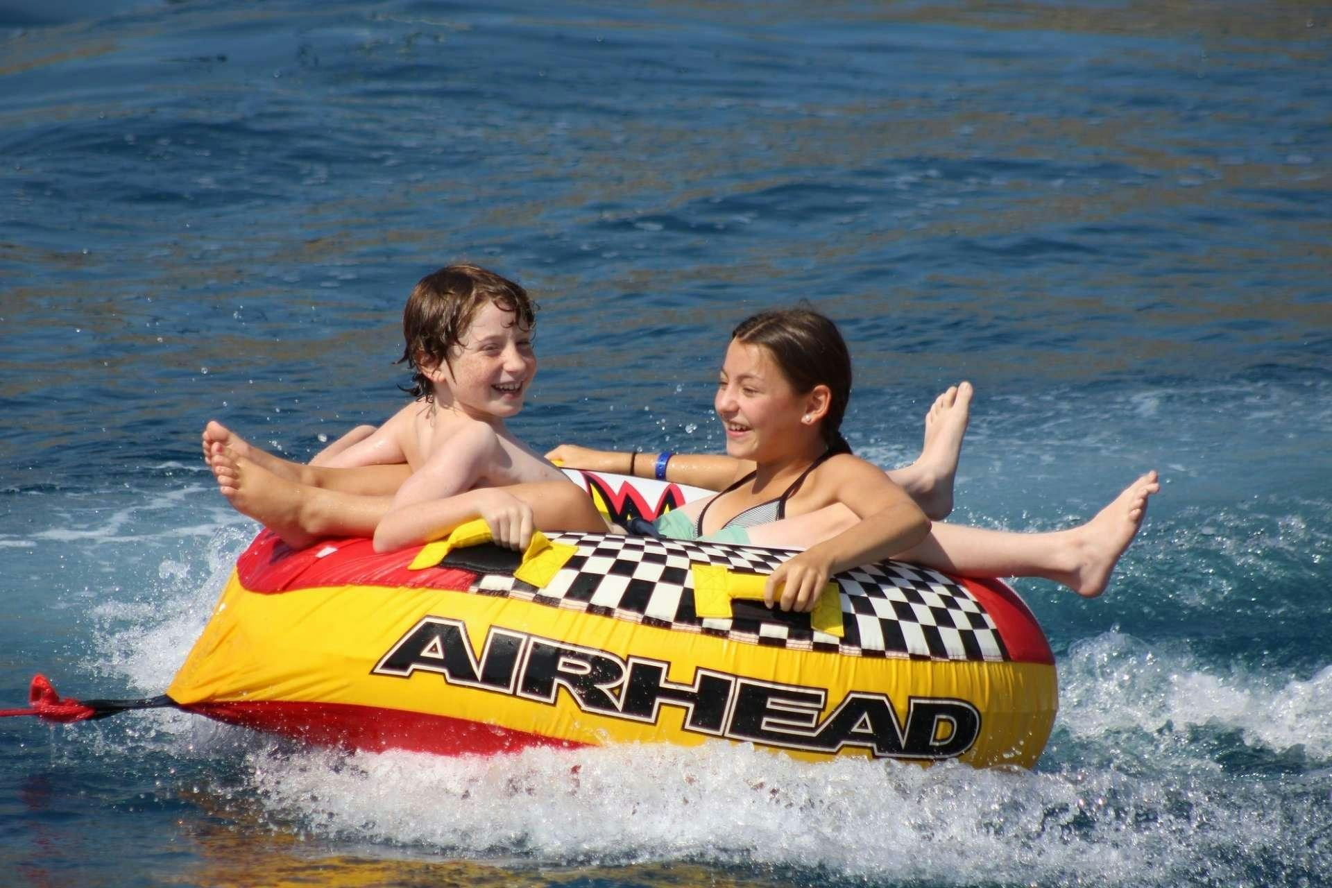 a man and woman in a raft in the water aboard ANAHITA Yacht for Charter