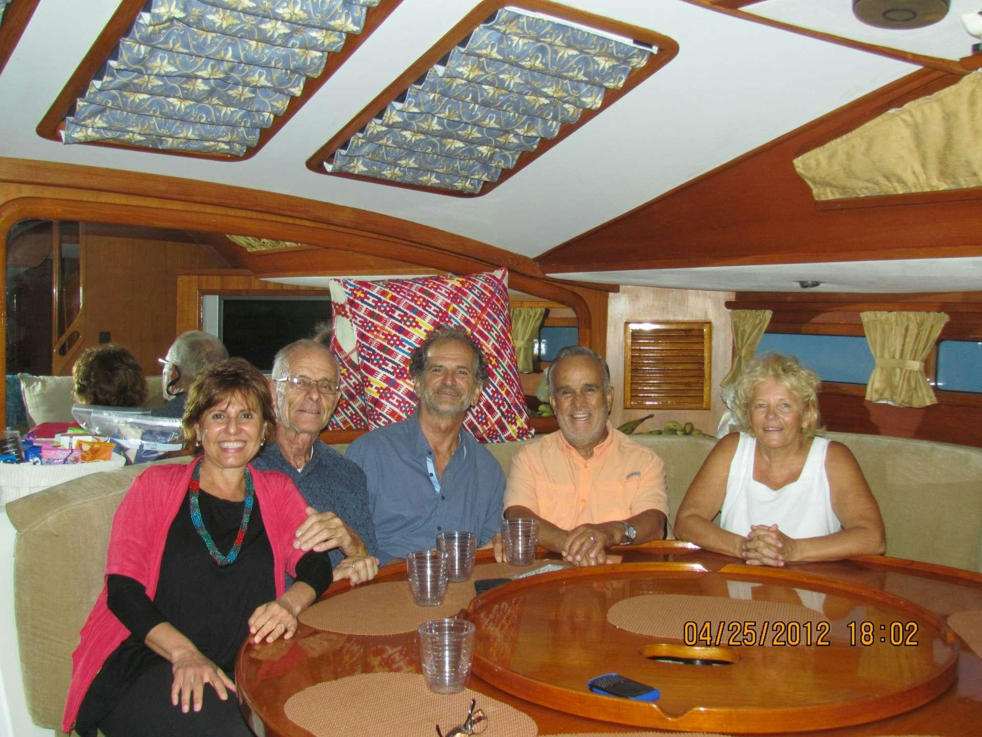 a group of people sitting around a table aboard ANAHITA Yacht for Charter