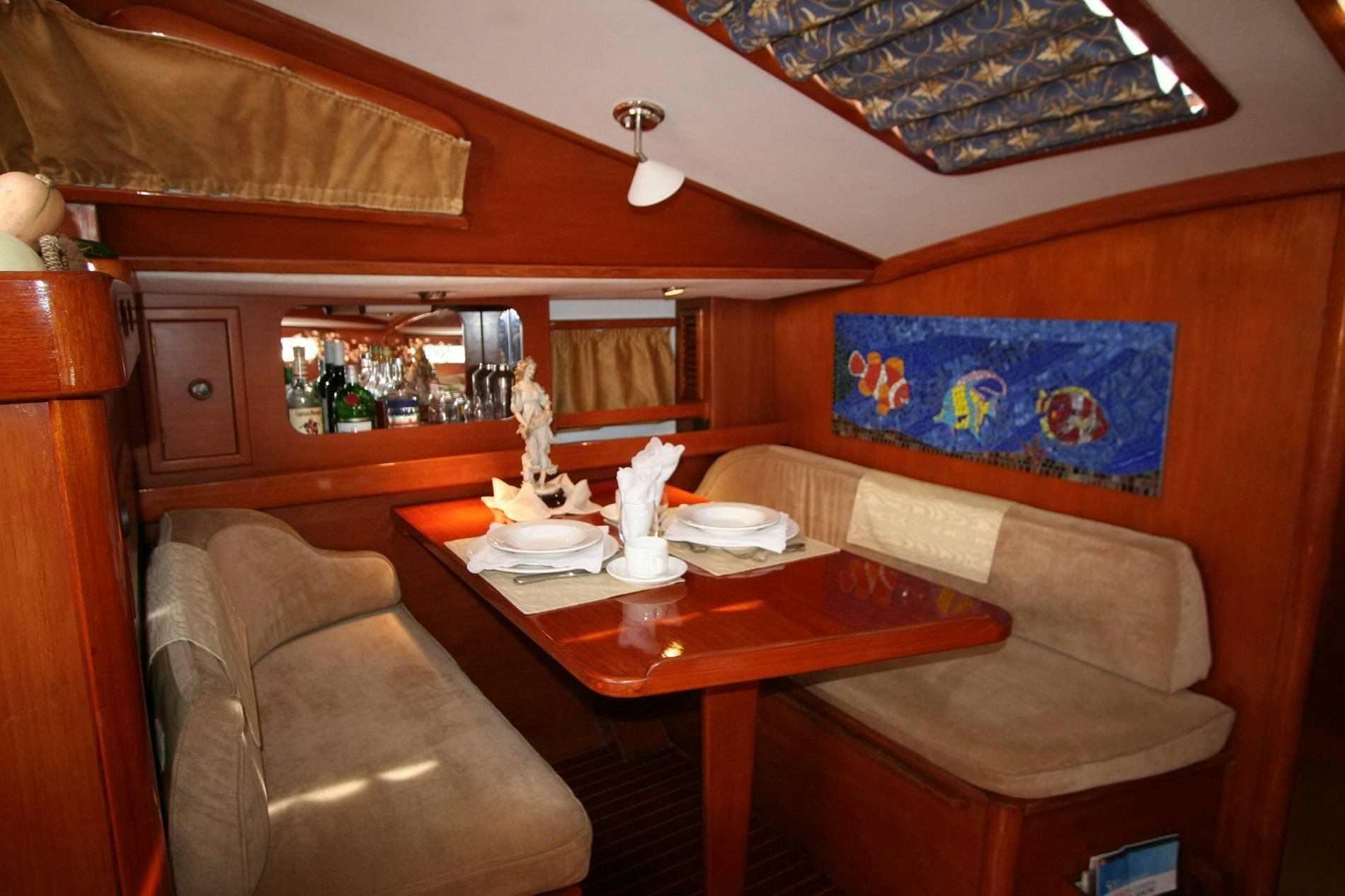 a dining table in a living room aboard ANAHITA Yacht for Charter