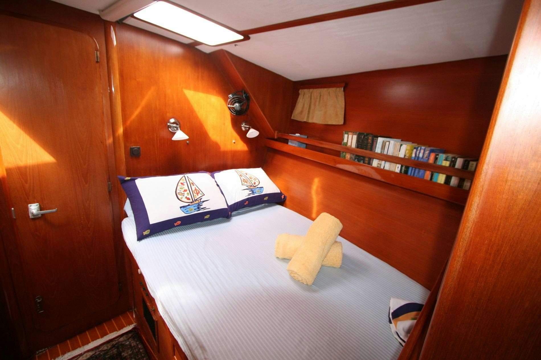 a bed in a room aboard ANAHITA Yacht for Charter
