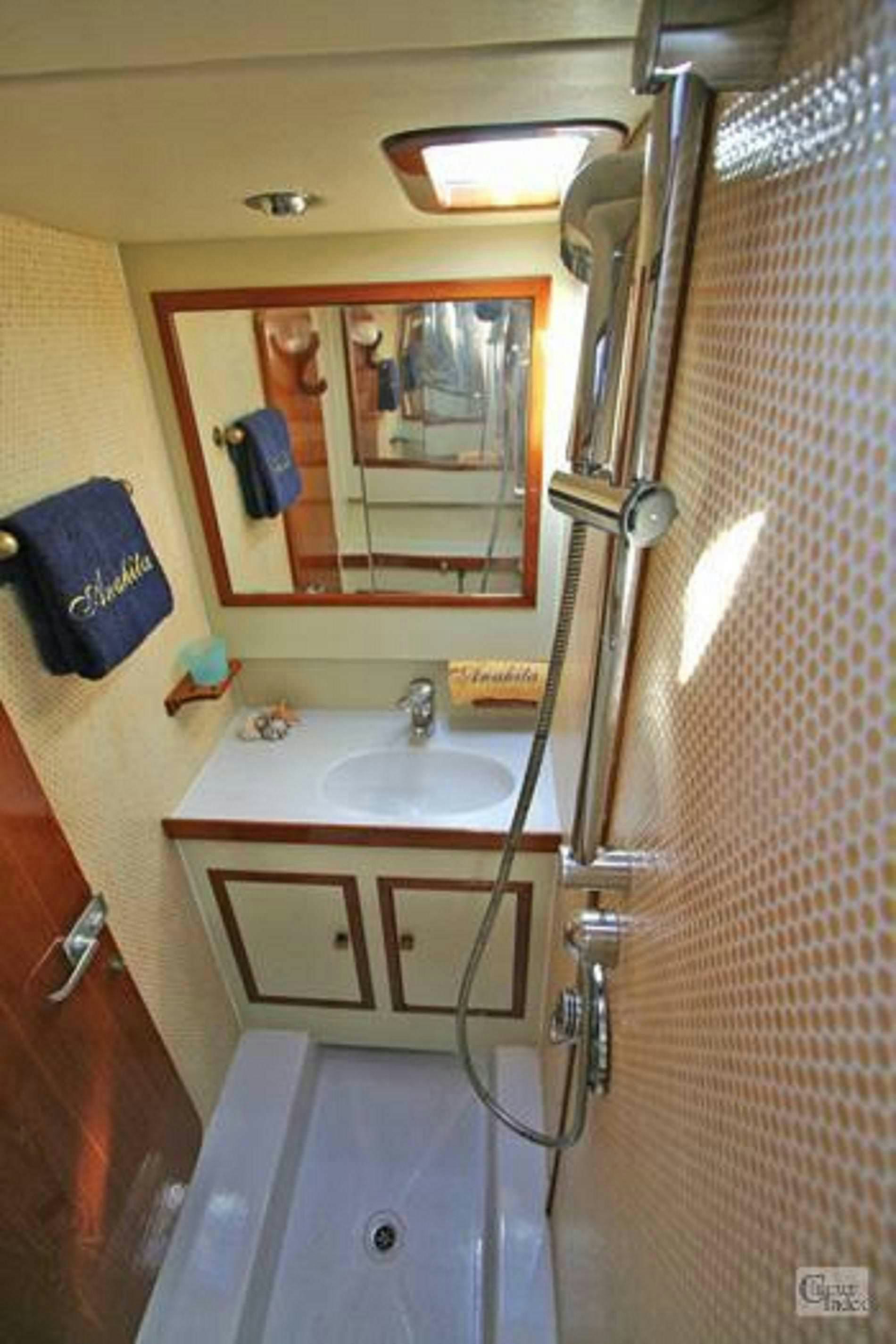 a bathroom with a mirror and sink aboard ANAHITA Yacht for Charter