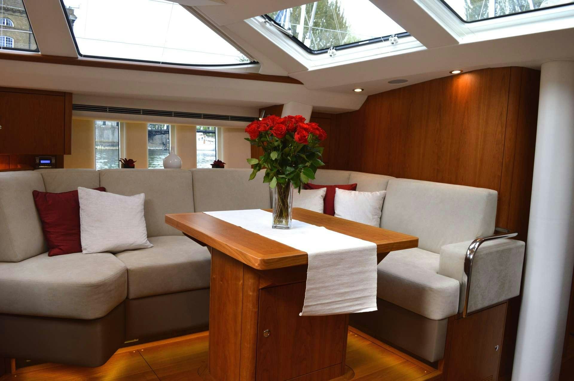 a room with a table and couches aboard SPIRIT Yacht for Charter
