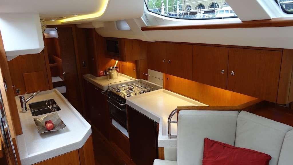 a kitchen with a sink and a couch aboard SPIRIT Yacht for Charter