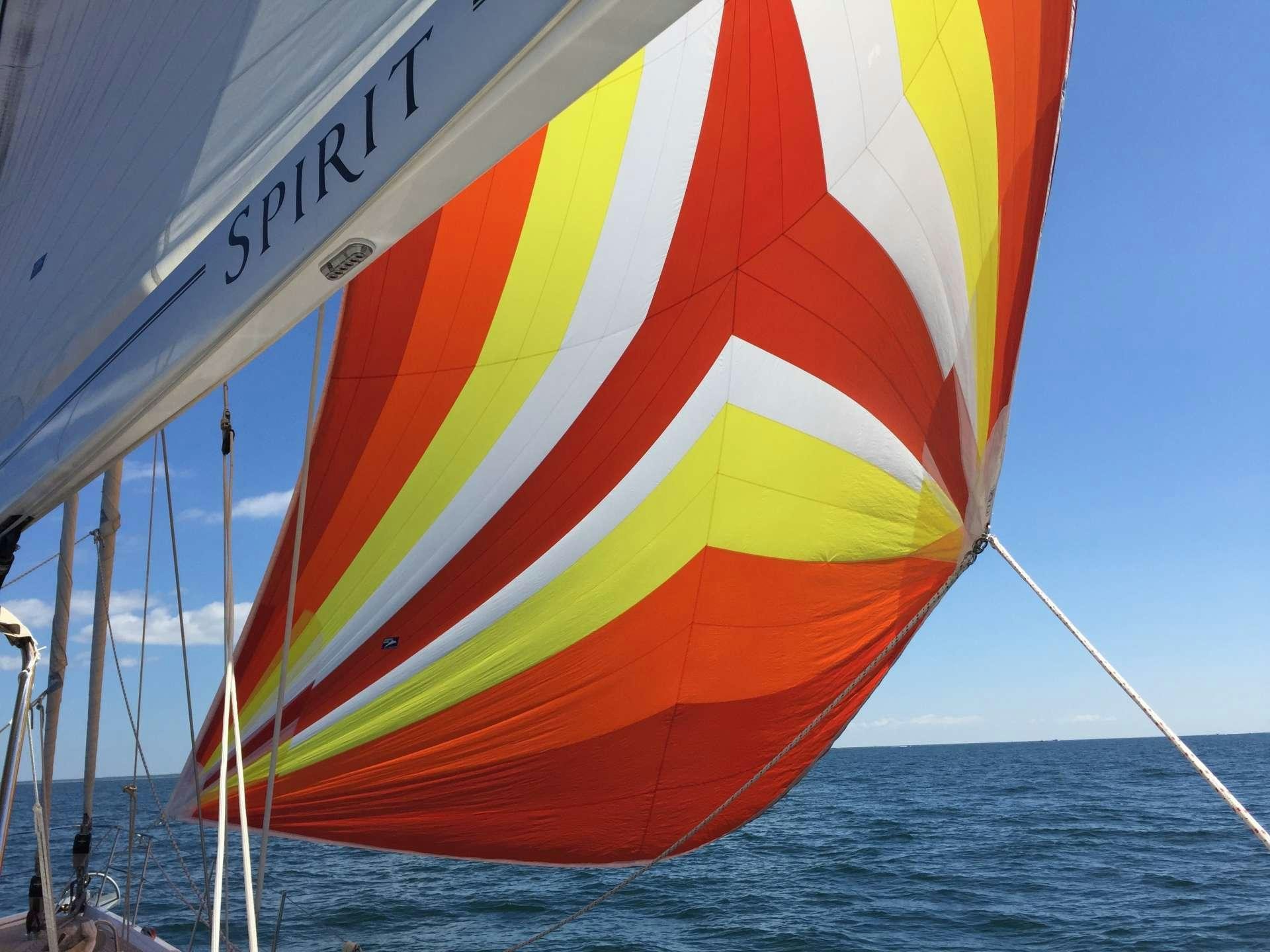 a sailboat with a rainbow flag aboard SPIRIT Yacht for Charter