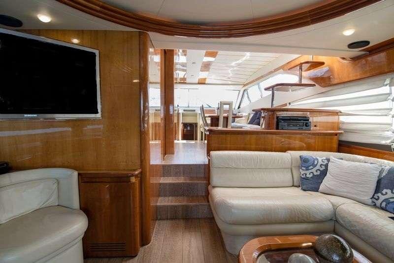 a living room with a couch and a television aboard ANANAS Yacht for Charter