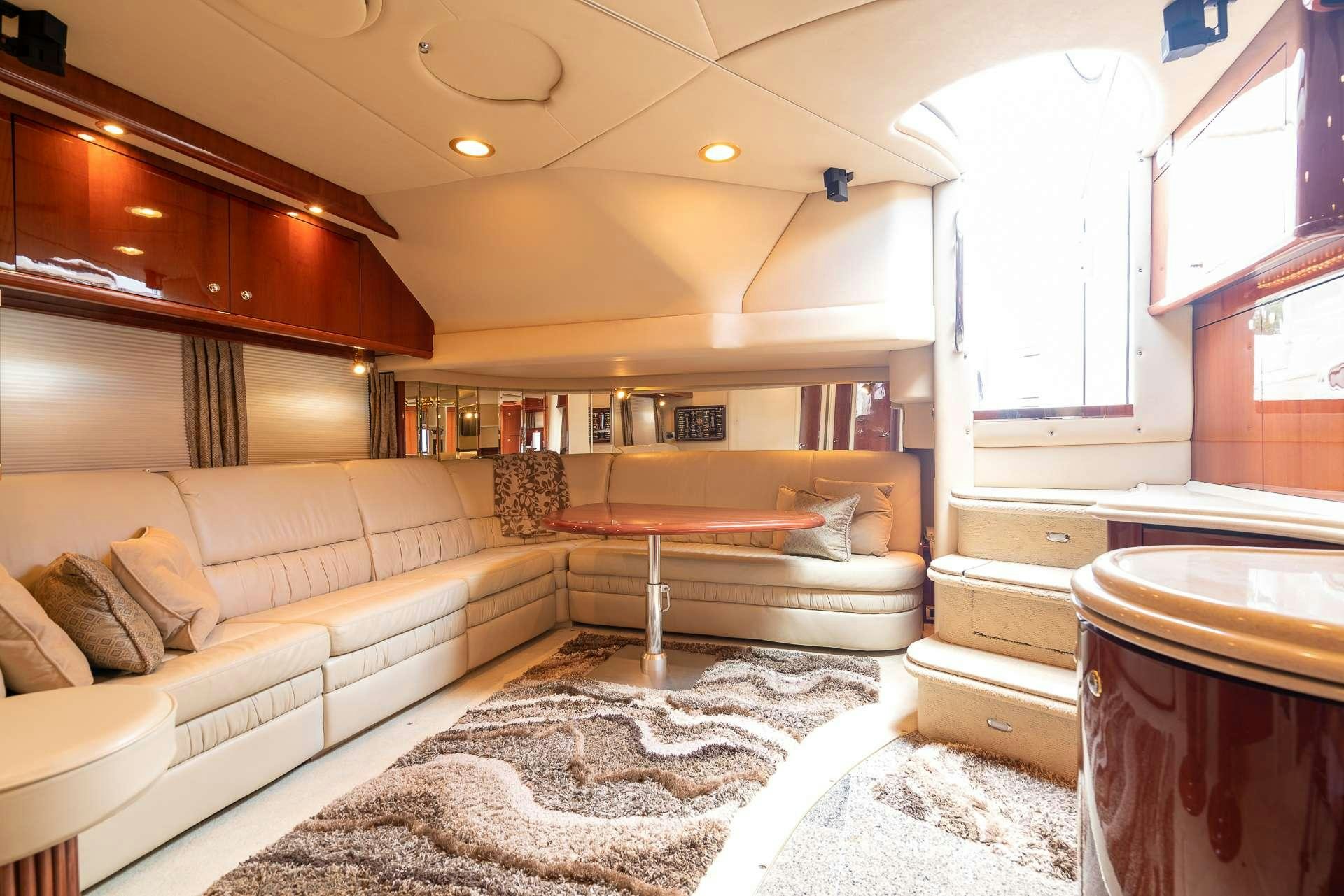 a room with a bed and a couch aboard XOXO Yacht for Charter