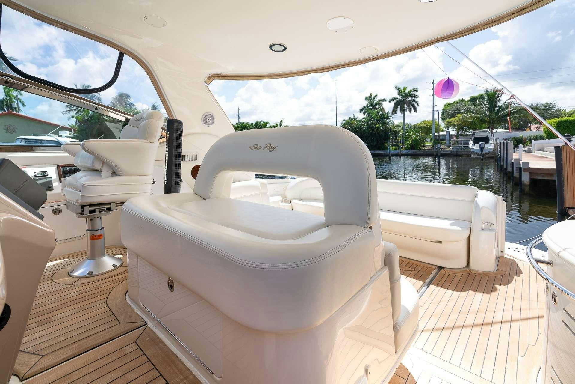 a white chair on a deck aboard XOXO Yacht for Charter