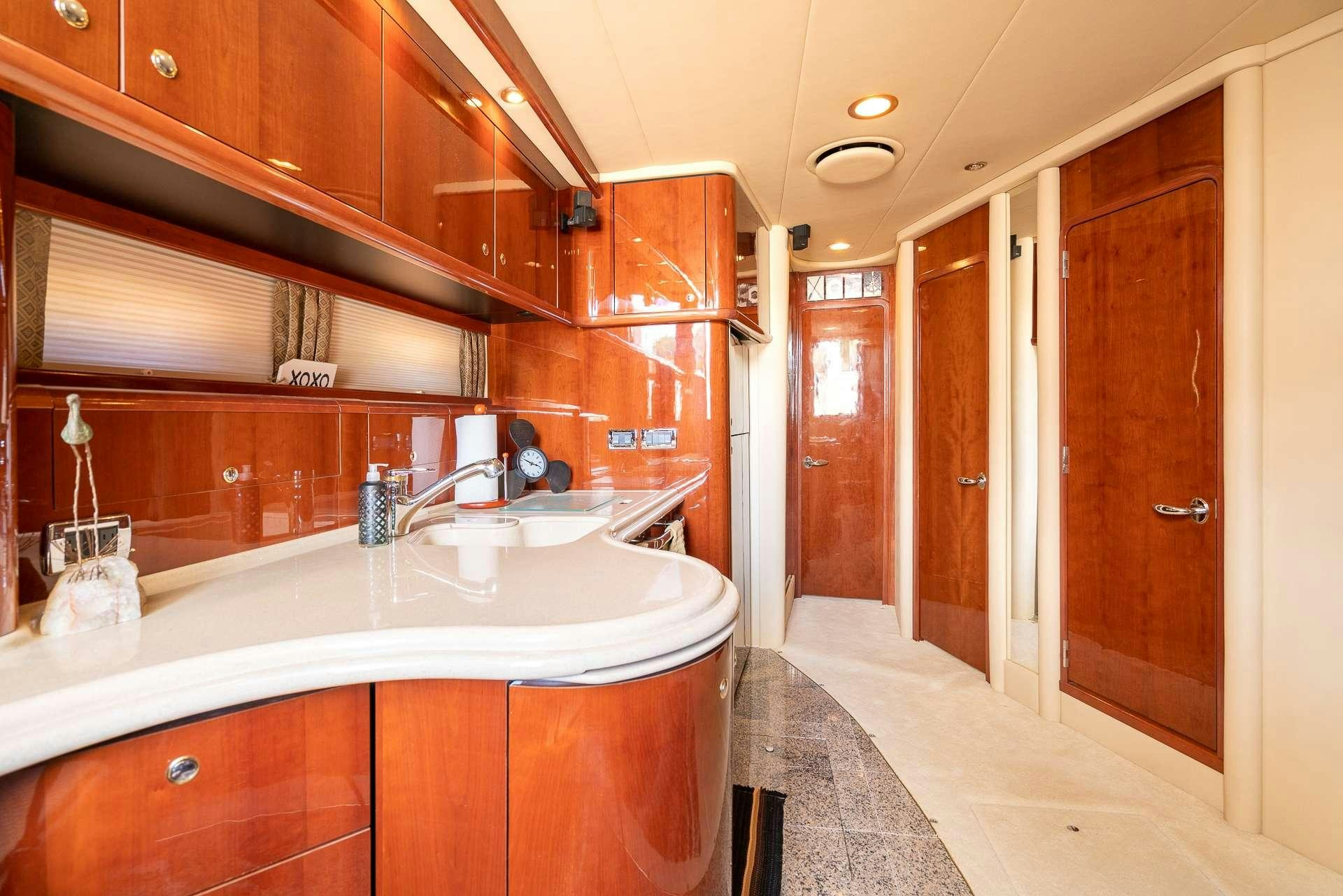 a bathroom with a sink and a mirror aboard XOXO Yacht for Charter