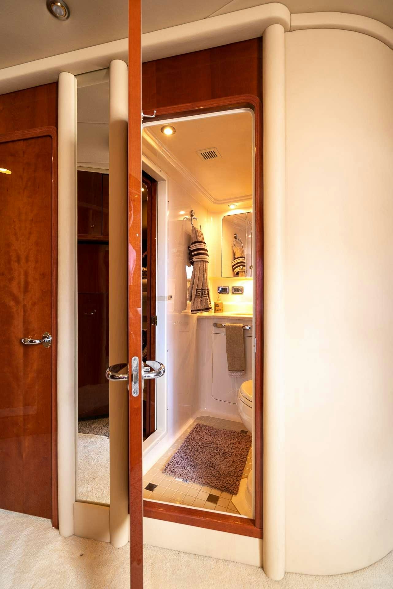 a bathroom with a glass shower aboard XOXO Yacht for Charter